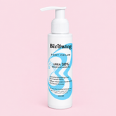 A 100 cm white pump bottle of Birdwing Foot Cream with a blue and white label, set against a solid light pink background.