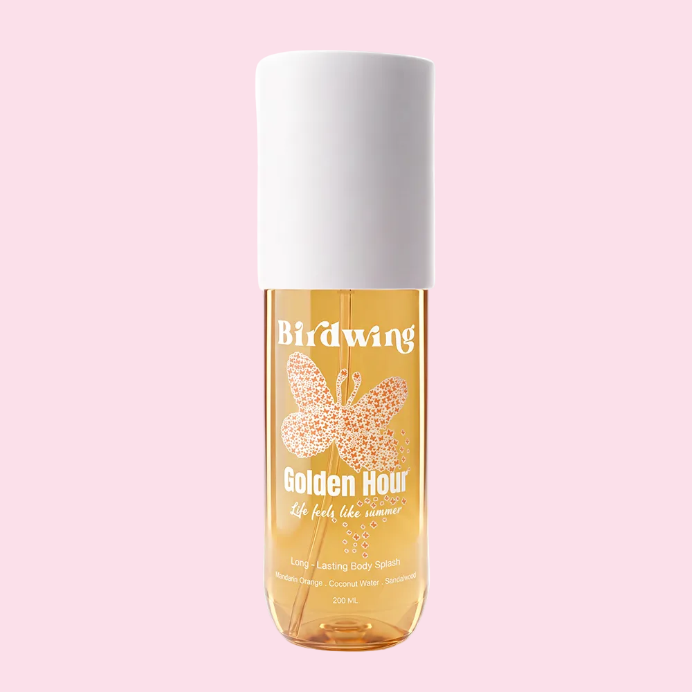 A 200 ml bottle of Birdwing Golden Hour Longing + Lasting Body Spray, featuring a translucent amber-colored bottle with a white cap and a butterfly graphic on the front label.